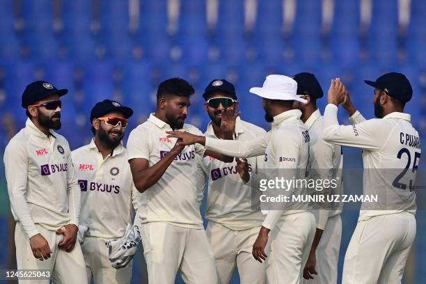 India's Mohammed Siraj celebrates with his teammates after the dismissal of the Bangladeshs Litton Das during the second day of the first cricket...