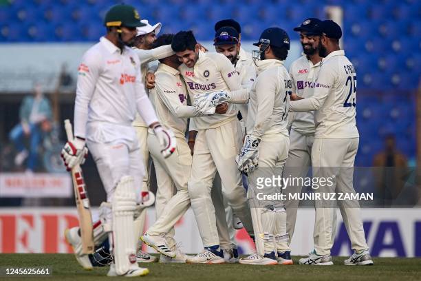 India's cricketers celebrate after the dismissal of Bangladesh's Nurul Hasan during the second day of the first cricket Test match between Bangladesh...