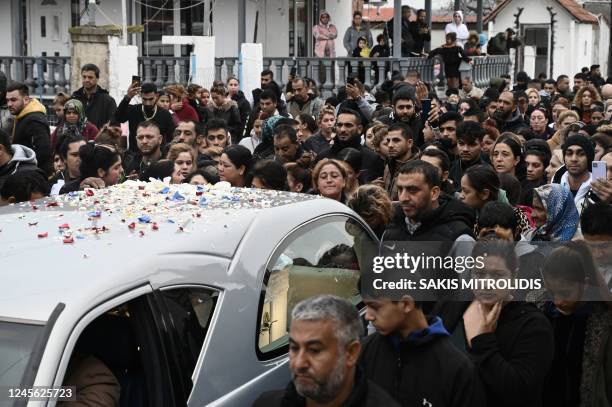 Relatives and friends of the 16-year-old Roma boy who was shot in the head by Greek police follow a hearse with the coffin during the funeral, in...
