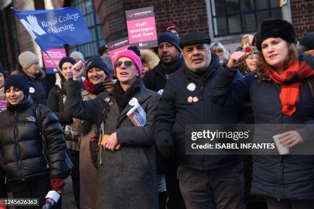 Supporters of nurses' strike and NHS shout slogans at a picket line outside St Mary's Hospital in west London on December 15, 2022. - UK nurses...