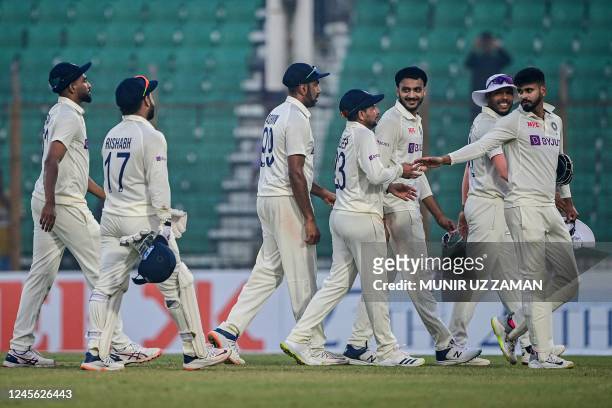 India's cricketers walk back to the pavilion after end of play of the second day of the first cricket Test match between Bangladesh and India at the...