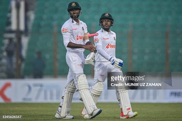 Bangladesh's Ebadot Hossain and Mehidy Hasan Miraz walks back to the pavilion after end of play of the second day of the first cricket Test match...