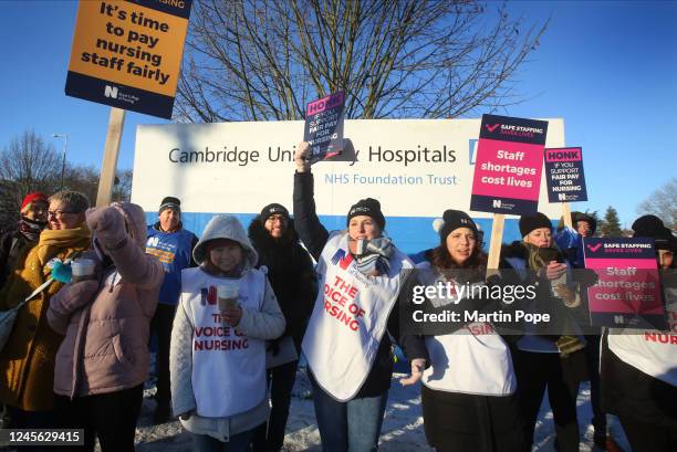 Nurses on the picket line outside Addenbrookes hospital acknowledge support from the passing traffic on December 15, 2022 in Cambridge, United...