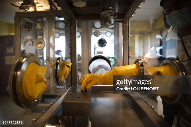 An employee trains on a "glove box", at the training school of the Orano la Hague reprocessing plant, in La Hague, northwestern France, on December...