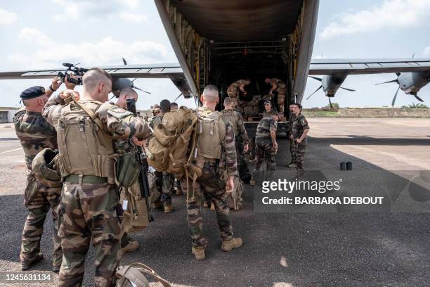 The last 47 French soldiers of the logistics mission are seen at Bangui airport on December 15, 2022 before boarding a C130 cargo plane. - French...