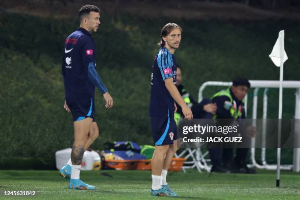 Croatia's midfielders Luka Modric and Ivan Perisic take part in a training session at Al Erssal Training Site 3 in Doha on December 15 ahead of their...