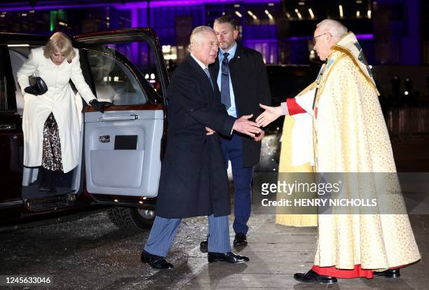 Britain's King Charles III is welcomed by Dean of Westminster David Hoyle upon arrival with Britain's Camilla, Queen Consort to attend the "Together...