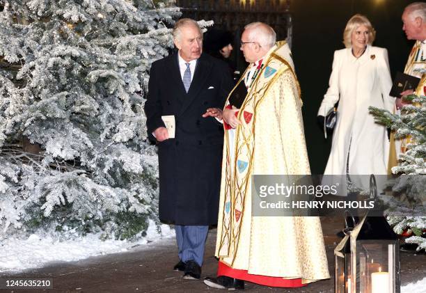 Britain's King Charles III speaks with Dean of Westminster David Hoyle upon arrival with Britain's Camilla, Queen Consort to attend "Together At...
