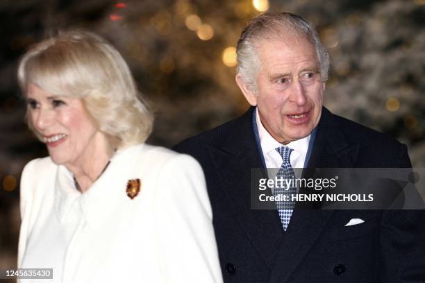 Britain's Camilla, Queen Consort and Britain's King Charles III arrive to attend "Together At Christmas Carol Service" at Westminster Abbey, in...