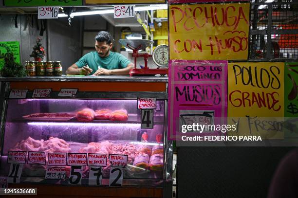 Vendor waits for customers at the Quinta Crespo municipal market in Caracas on December 15, 2022. - Venezuela announced on December 10 that it would...