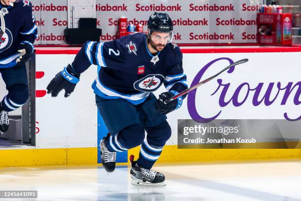 Dylan DeMelo of the Winnipeg Jets hits the ice prior to puck drop against the Nashville Predators at the Canada Life Centre on December 15, 2022 in...