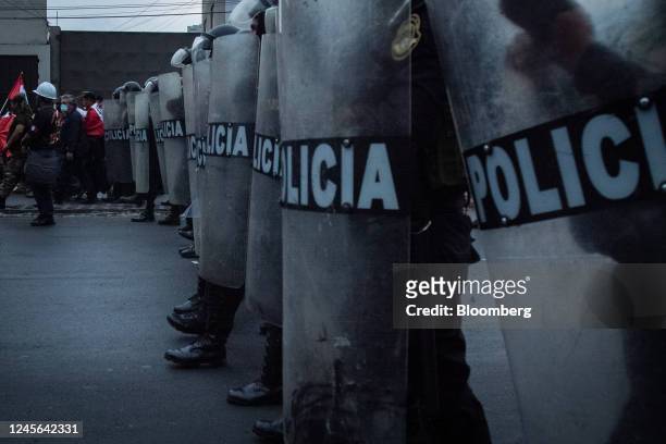 Riot police officers stand guard during protests on Avenida de Pierola in Lima, Peru, on Thursday, Dec. 15, 2022. Peru has declared a nationwide...