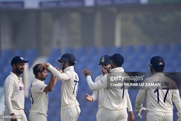 Indias cricketers celebrate after the dismissal of the Bangladeshs Ebadot Hossain during the third day of the first cricket Test match between...