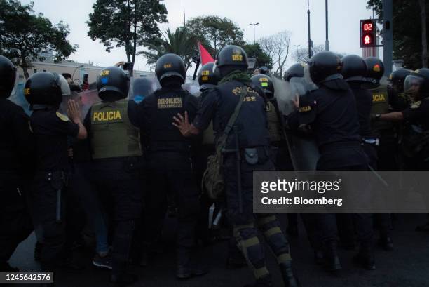 Riot police officers clash with demonstrators during protests on Avenida de Pierola in Lima, Peru, on Thursday, Dec. 15, 2022. Peru has declared a...