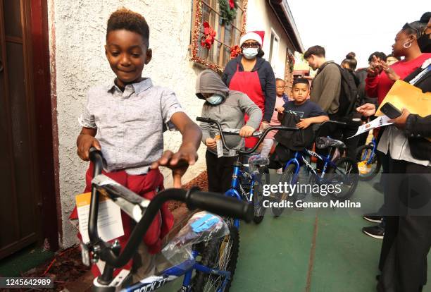 Aiden Abiy from Compton Avenue Elementary School, walks away with his new bike at the Parents of Watts Working With Youth & Adults, Inc., annual...