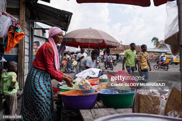 Trader displays items for sale at the Rutshuru parking lot in Goma, eastern Democratic Republic of Congo, on December 2, 2022. - M23 rebels have cut...