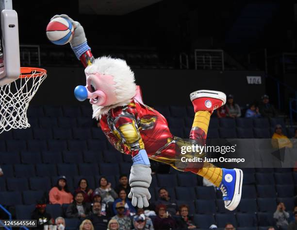 The Ontario Clippers mascot, Kid Condor, goes up for a dunk during a time out in the game between the Ontario Clippers and the South Bay Lakers on...