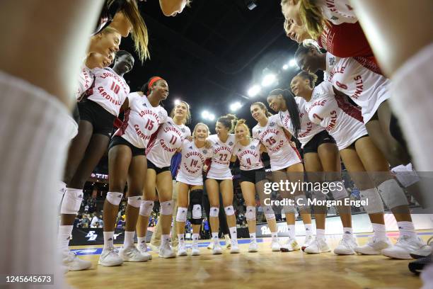 The Louisville Cardinals huddle in celebration after a 3-2 win against the Pitt Panthers during the Division I Womens Volleyball Semifinals held at...