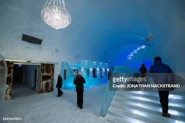 People visit the Ice hotel 365 in the village of Jukkasjarvi, near Kiruna, in Swedish Lapland, on November 20, 2022. - Ice hotel 365 was completed in...