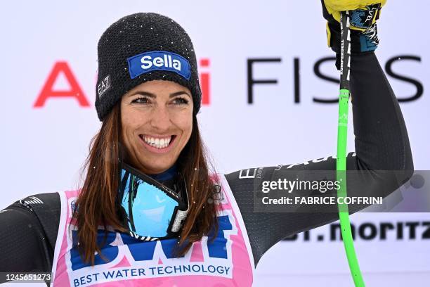 Winner, Italy's Elena Curtoni celebrates on the podium at the end of the third run of the Women's Downhill event during the FIS Alpine Ski World Cup...