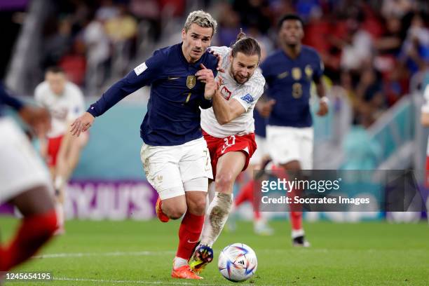 Antoine Griezmann of France, Gregorz Krychowiak of Poland during the World Cup match between France v Poland at the Al Thumama Stadium on December 4,...