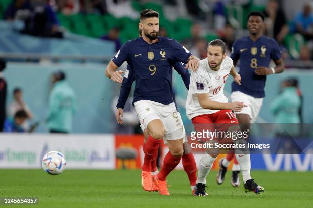 Oliver Giroud of France, Gregorz Krychowiak of Poland during the World Cup match between France v Poland at the Al Thumama Stadium on December 4,...