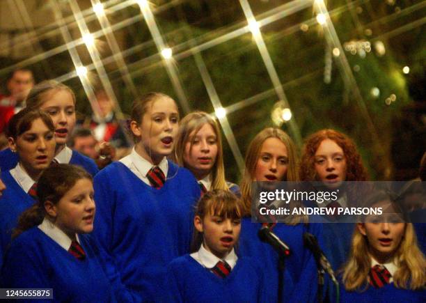 Year nine girls from Soham Village college sing a christmas carol, 19 December 2002, at Ely Cathedral, Cambridgeshire, in memory of Holly Wells and...