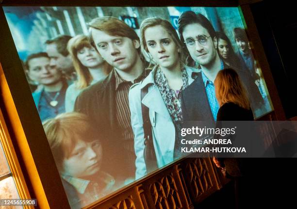 Visitor looks at a screen showing an excerpt of a film during the opening of the European exhibition of Harry Potter in Vienna, Austria on December...