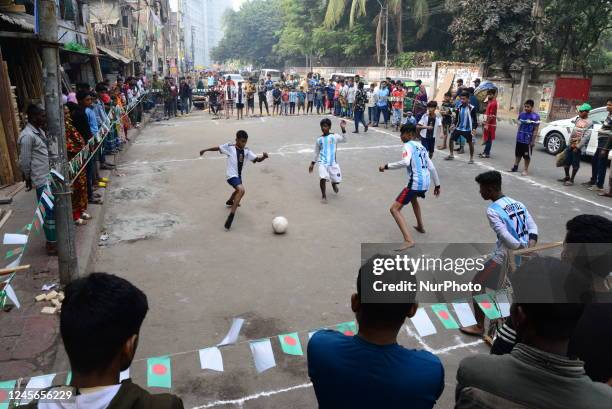 Children wearing jersey Argentina and France play football on the street during the FIFA World Cup tournament in Qatar, in Dhaka, Bangladesh, on...