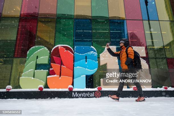 Delegates of the COP15 take photos of the freshly fallen snow around the United Nations Biodiversity Conference in Montreal, Quebec, Canada on...