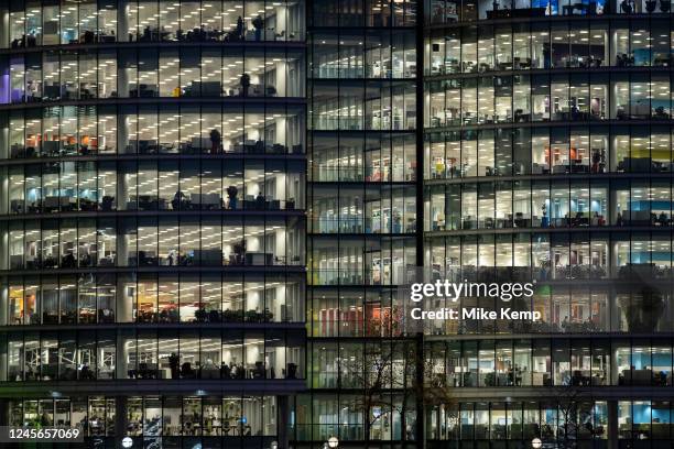 Office buildings at More London lit up at night on 7th December 2022 in London, United Kingdom. This area is a recent development which is now...