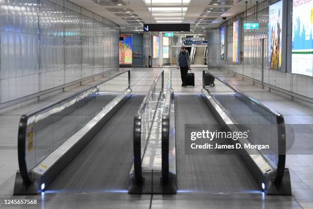 Solo traveller approaches the travelator at the domestic airport terminal on June 05, 2020 in Sydney, Australia. Restrictions continue to ease around...