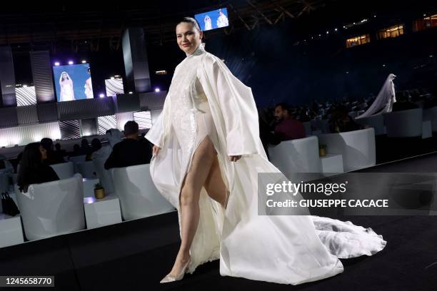 Brazilian model Adriana Lima presents a creation during the Qatar Fashion United by CR Runway held at the 974 Stadium in Doha, on December 16 on the...