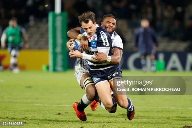 Bordeaux' French fullback Nans Ducuing is tackled by Sharks' Congolese flancker Vincent Tshituka during the European Rugby Champions Cup pool A rugby...