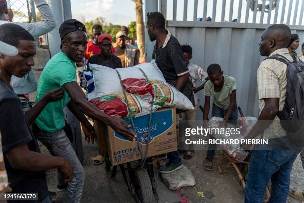 Haitians carry goods from the Dominican Republic, in Belladere, Haiti at the Dominican Republic-Haiti border on December 16, 2022.