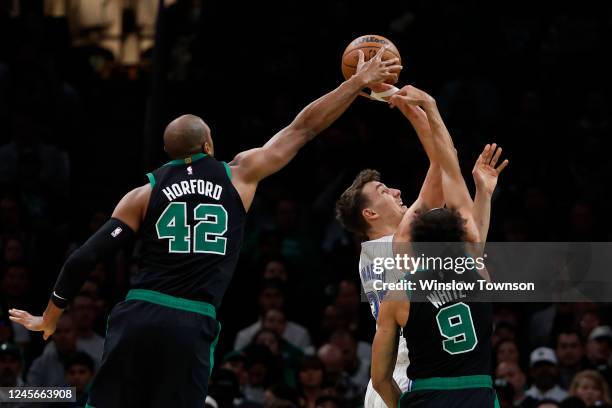 Al Horford of the Boston Celtics blocks a shot by Franz Wagner of the Orlando Magic during the first quarter at TD Garden on December 16, 2022 in...
