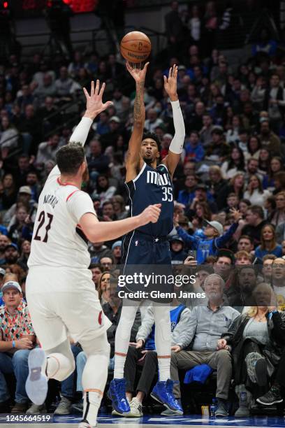 Christian Wood of the Dallas Mavericks shoots a three point basket during the game against the Portland Trail Blazers on December 16, 2022 at the...