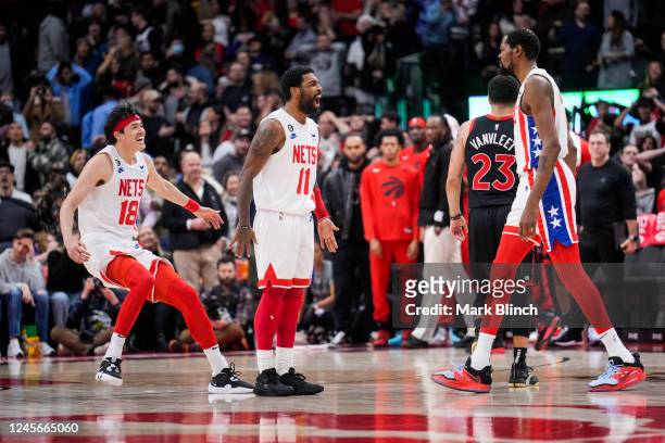 Kyrie Irving of the Brooklyn Nets celebrates his game winning shot with Kevin Durant and Yuta Watanabe against the Toronto Raptors during the second...