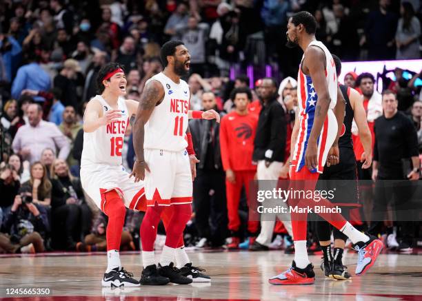 Kyrie Irving of the Brooklyn Nets celebrates his game winning shot with Kevin Durant and Yuta Watanabe against the Toronto Raptors during the second...