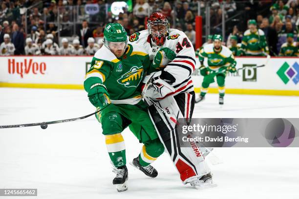 Petr Mrazek of the Chicago Blackhawks checks Sam Steel of the Minnesota Wild in the second period of the game at Xcel Energy Center on December 16,...