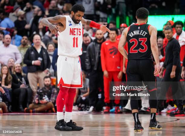 Kyrie Irving of the Brooklyn Nets celebrates his game winning shot in front of Fred VanVleet of the Toronto Raptors at the end of their basketball...