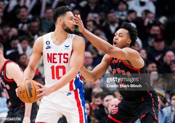 Ben Simmons of the Brooklyn Nets is guarded by Scottie Barnes of the Toronto Raptors during the second half of their basketball game at the...