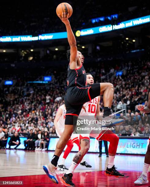 Scottie Barnes of the Toronto Raptors goes to the basket against Ben Simmons of the Brooklyn Nets during the second half of their basketball game at...