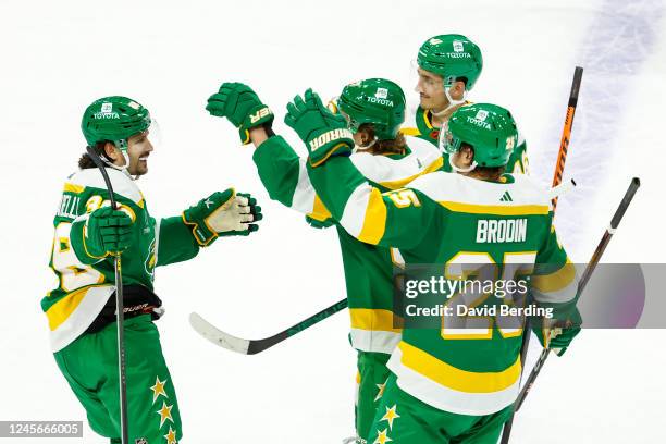 Mats Zuccarello of the Minnesota Wild celebrates his hat trick against the Chicago Blackhawks with teammates in the third period of the game at Xcel...