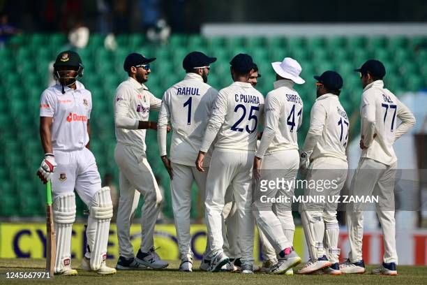 Indias cricketers celebrate after the dismissal of Bangladesh's Najmul Hossain Shanto during the fourth day of the first cricket Test match between...