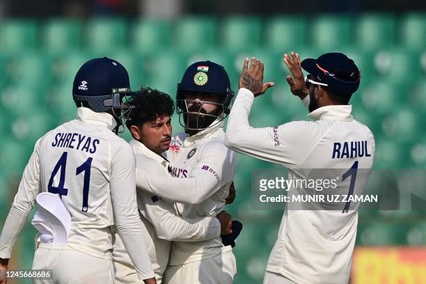 Indias Kuldeep Yadav celebrates with teammates after the dismissal of Bangladesh's Litton Das during the fourth day of the first cricket Test match...