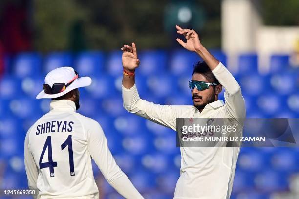 Indias Axar Patel celebrates with teammates after the dismissal of the Bangladesh's Mushfiqur Rahim during the fourth day of the first cricket Test...