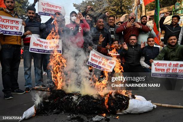 Activists from Bharatiya Janata Yuva Morcha shout slogans as they burn an effigy of Pakistani foreign minister Bilawal Bhutto Zardari's over his...