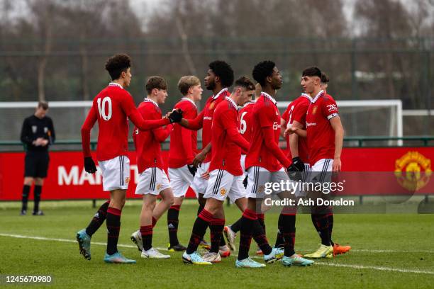 Ethan Wheatley of Manchester United U18s celebrates the first goal with team-mates during the U18 Premier League match between Manchester United U18...