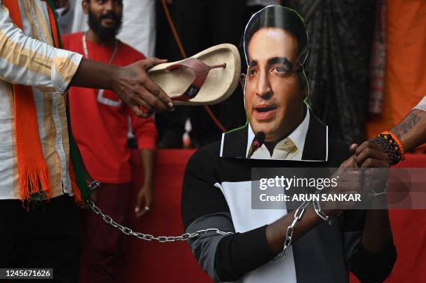 Activists from Bharatiya Janata Yuva Morcha shout slogans and prepare to burn a portrait of Pakistani foreign minister Bilawal Bhutto Zardari's over...